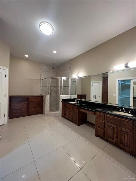 full bathroom with a stall shower, tile patterned flooring, and vanity