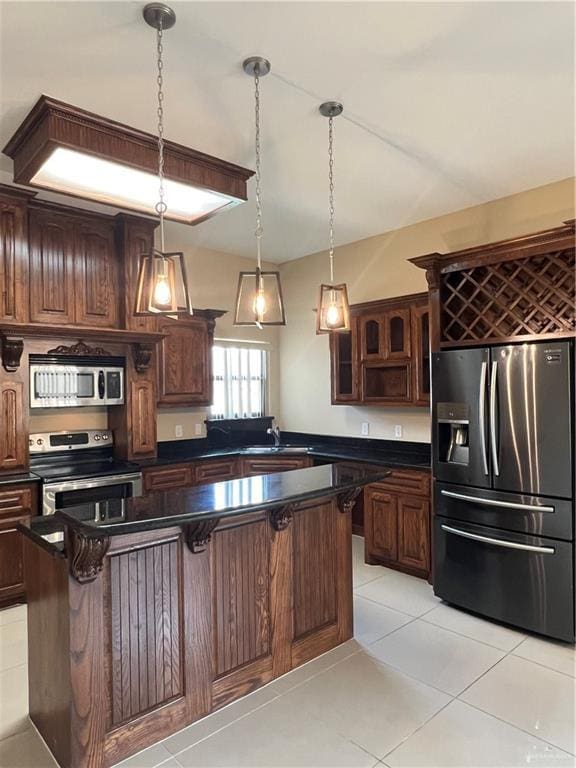 kitchen with appliances with stainless steel finishes, dark countertops, glass insert cabinets, and dark brown cabinetry