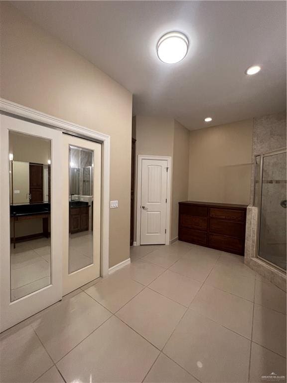 interior space with light tile patterned floors, recessed lighting, and baseboards