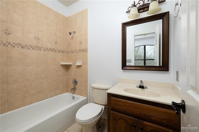 full bathroom with toilet, vanity, and tiled shower / bath