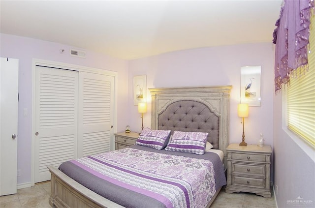 bedroom with a closet and light tile patterned flooring