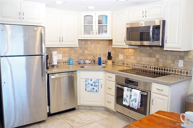 kitchen with sink, white cabinets, and appliances with stainless steel finishes