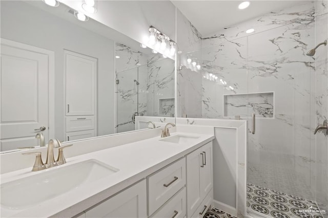 bathroom with vanity and a shower with door