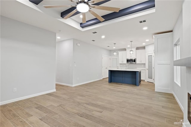 unfurnished living room with ceiling fan