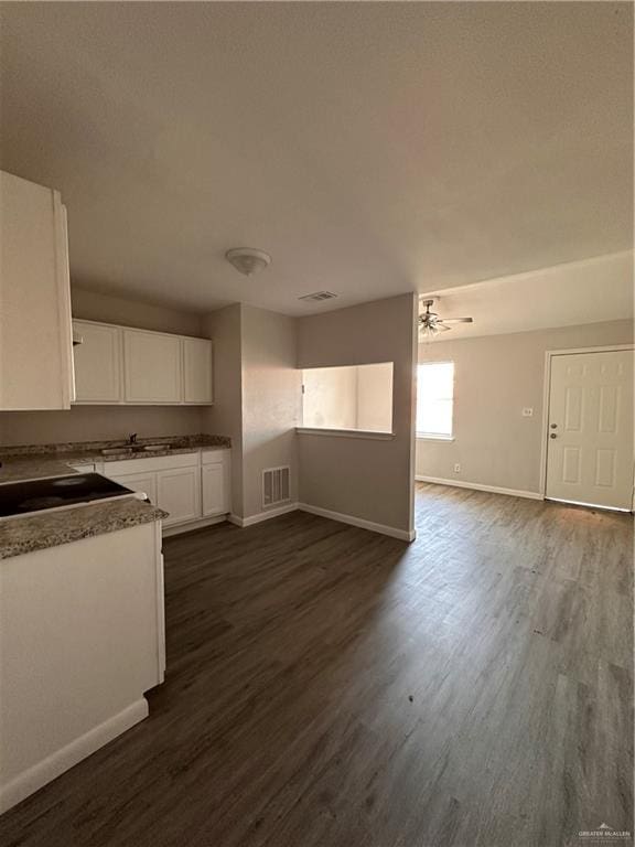 kitchen featuring ceiling fan, sink, white cabinetry, and dark wood-type flooring