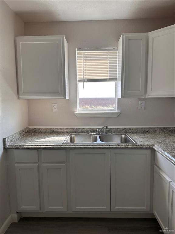 kitchen with sink, white cabinets, and dark hardwood / wood-style floors