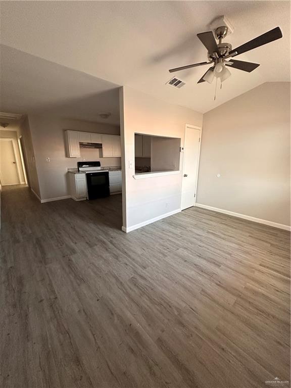 unfurnished living room with dark hardwood / wood-style floors, ceiling fan, and lofted ceiling