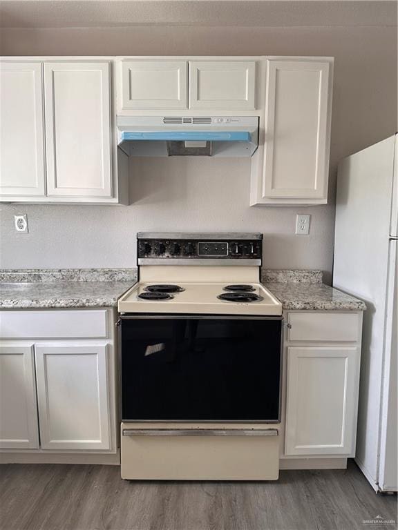 kitchen featuring white cabinetry, hardwood / wood-style floors, light stone counters, and white appliances