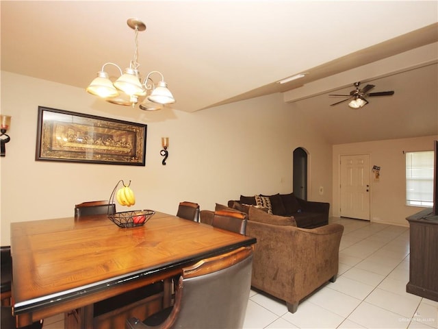 dining space featuring ceiling fan with notable chandelier, light tile patterned floors, and lofted ceiling with beams