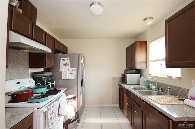 kitchen featuring light tile patterned floors, white appliances, dark brown cabinets, and sink