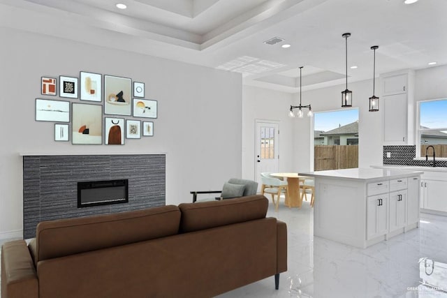 living room featuring a tray ceiling