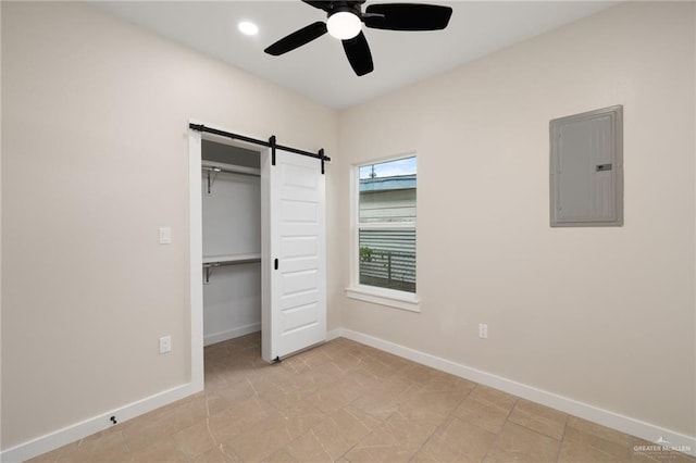 505 E Hawk Ave E, Pharr, TX 78577 - unfurnished bedroom featuring electric panel, a barn door, a closet, and a ceiling fan