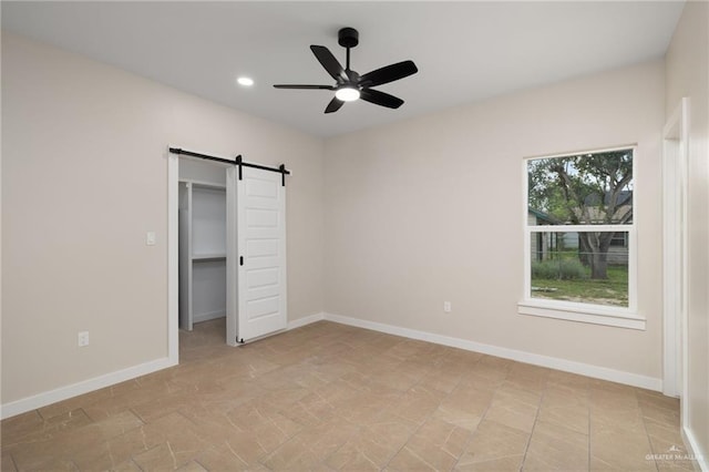 505 E Hawk Ave E, Pharr, TX 78577 - unfurnished bedroom with a barn door, recessed lighting, a walk in closet, and a ceiling fan