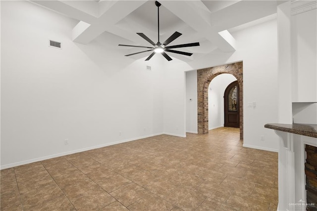 unfurnished living room with coffered ceiling, beam ceiling, and ceiling fan