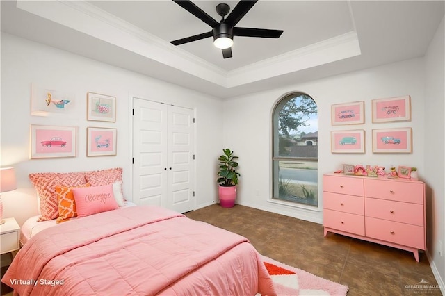 bedroom featuring crown molding, ceiling fan, a raised ceiling, and a closet