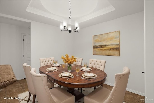 tiled dining area featuring a raised ceiling and a chandelier