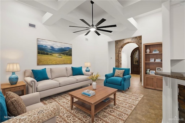 living room featuring ceiling fan and beam ceiling