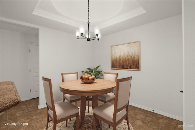 tiled dining space featuring a notable chandelier and a tray ceiling