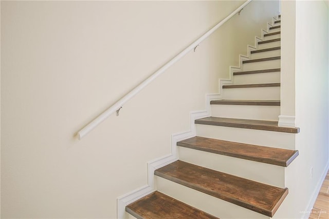 stairway featuring hardwood / wood-style floors