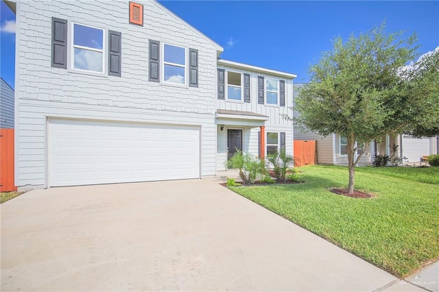 view of front of property with a garage and a front lawn