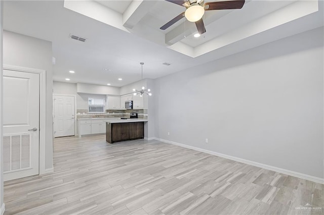 kitchen with a kitchen island, ceiling fan with notable chandelier, decorative light fixtures, white cabinetry, and light wood-type flooring