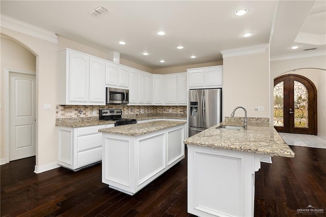 8605 Estrella Dr, Elsa, TX 78538 - kitchen with a sink, appliances with stainless steel finishes, light stone countertops, and backsplash