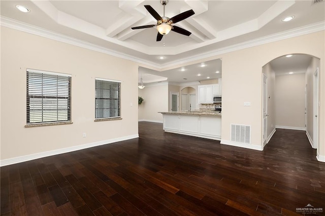 8605 Estrella Dr, Elsa, TX 78538 - unfurnished living room with visible vents, ceiling fan, dark wood-style floors, recessed lighting, and arched walkways