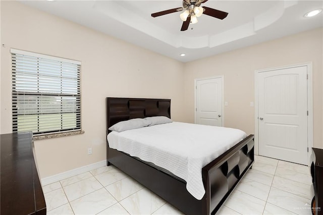 8605 Estrella Dr, Elsa, TX 78538 - bedroom featuring ceiling fan, baseboards, a raised ceiling, marble finish floor, and recessed lighting
