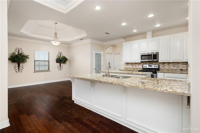 8605 Estrella Dr, Elsa, TX 78538 - kitchen with white cabinets, light stone countertops, appliances with stainless steel finishes, a sink, and backsplash