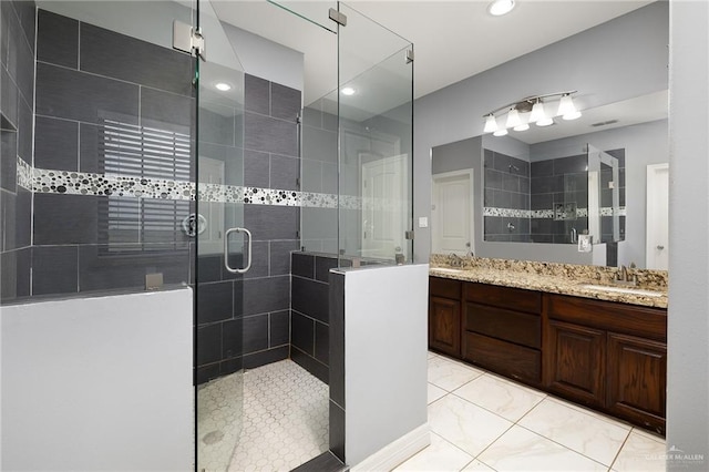 8605 Estrella Dr, Elsa, TX 78538 - bathroom featuring a sink, a shower stall, recessed lighting, and double vanity