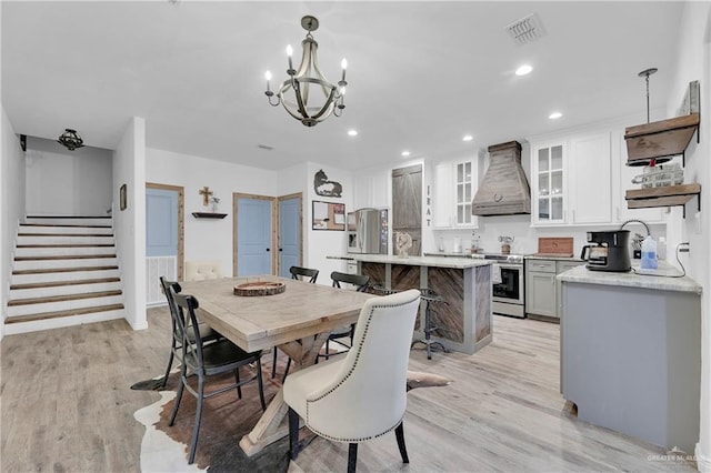 dining room featuring stairs, recessed lighting, visible vents, and light wood-style floors