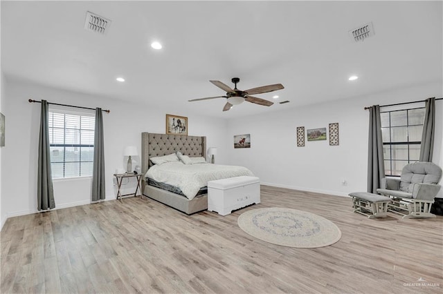 bedroom featuring wood finished floors, visible vents, and recessed lighting