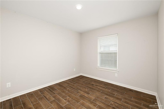 unfurnished room featuring dark wood-type flooring