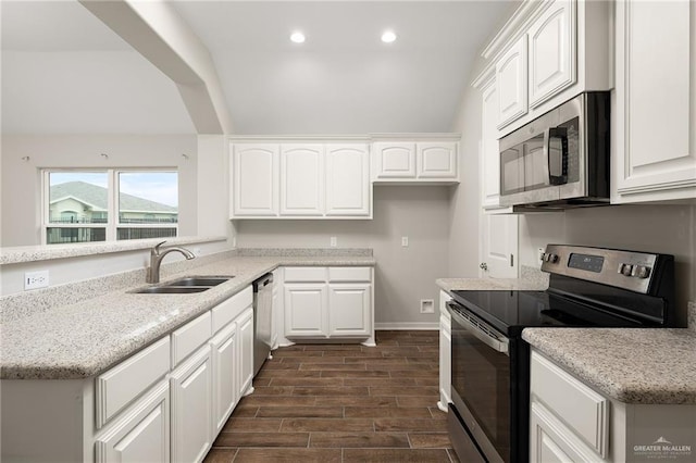 kitchen featuring light stone counters, appliances with stainless steel finishes, sink, and white cabinets