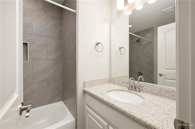 bathroom featuring vanity and tiled shower / bath combo