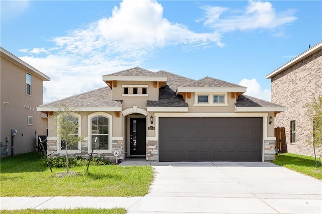 3213 El Paso Dr, Weslaco, TX 78599 - view of front facade with stucco siding, stone siding, and an attached garage
