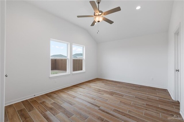 3213 El Paso Dr, Weslaco, TX 78599 - spare room with vaulted ceiling, a ceiling fan, wood finished floors, baseboards, and recessed lighting