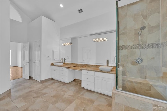 412 Sabine Ct, Mission, TX 78572 - full bath featuring double vanity, a shower stall, and high vaulted ceiling