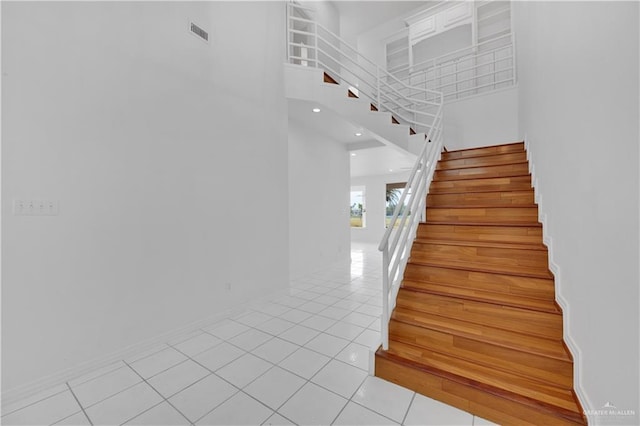 412 Sabine Ct, Mission, TX 78572 - staircase featuring a high ceiling, tile patterned flooring, and baseboards