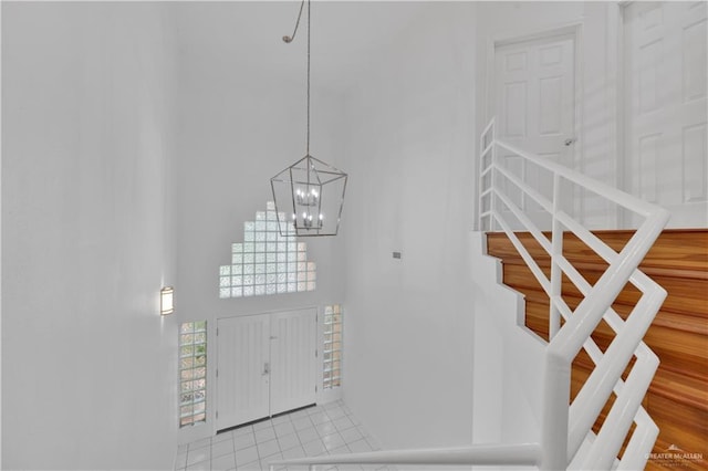 412 Sabine Ct, Mission, TX 78572 - foyer with a towering ceiling, stairs, a chandelier, and light tile patterned flooring