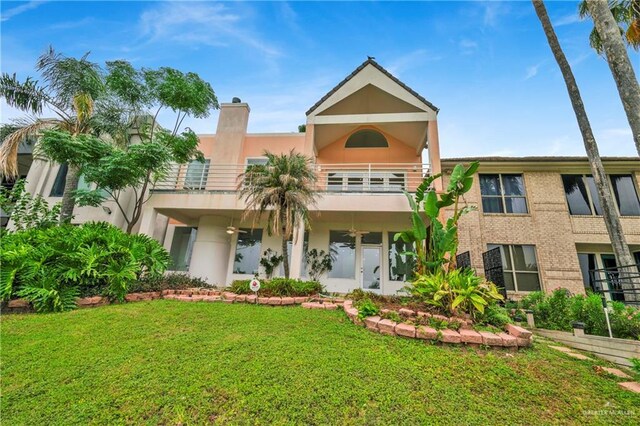412 Sabine Ct, Mission, TX 78572 - view of front facade featuring a balcony, french doors, a front yard, and stucco siding