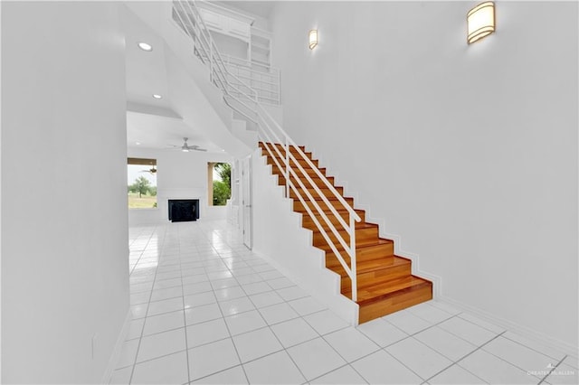 412 Sabine Ct, Mission, TX 78572 - staircase featuring tile patterned flooring, recessed lighting, a fireplace, ceiling fan, and baseboards