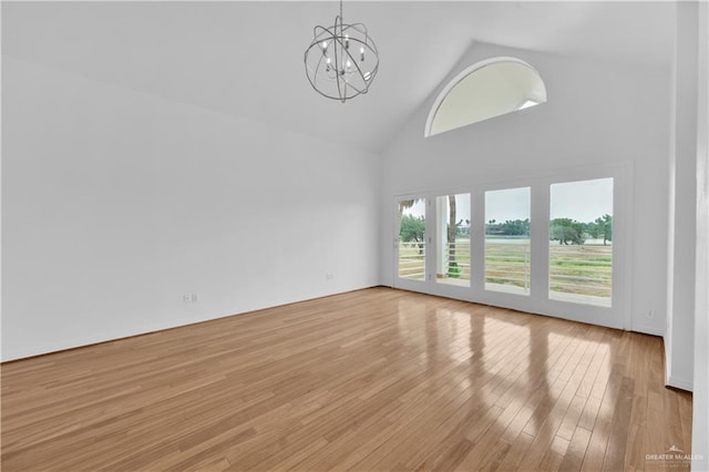 412 Sabine Ct, Mission, TX 78572 - unfurnished room featuring a chandelier, high vaulted ceiling, and light wood-style flooring