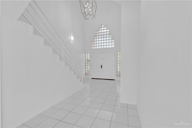 412 Sabine Ct, Mission, TX 78572 - entrance foyer featuring a towering ceiling, a chandelier, light tile patterned floors, and stairs