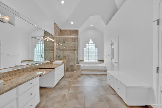 412 Sabine Ct, Mission, TX 78572 - bathroom featuring vaulted ceiling, a garden tub, a shower stall, recessed lighting, and vanity