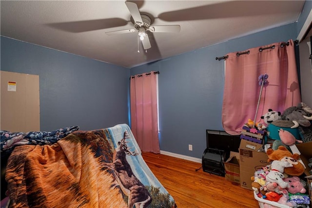 bedroom with ceiling fan and hardwood / wood-style floors