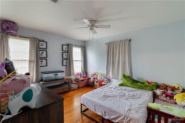 bedroom with light wood-type flooring and ceiling fan