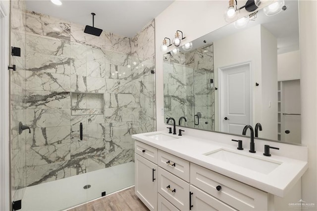 bathroom with vanity, wood-type flooring, and a shower with door