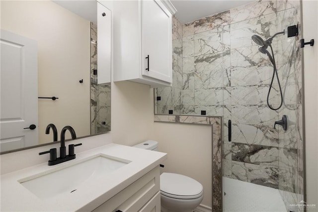 bathroom featuring vanity, toilet, and a shower with door