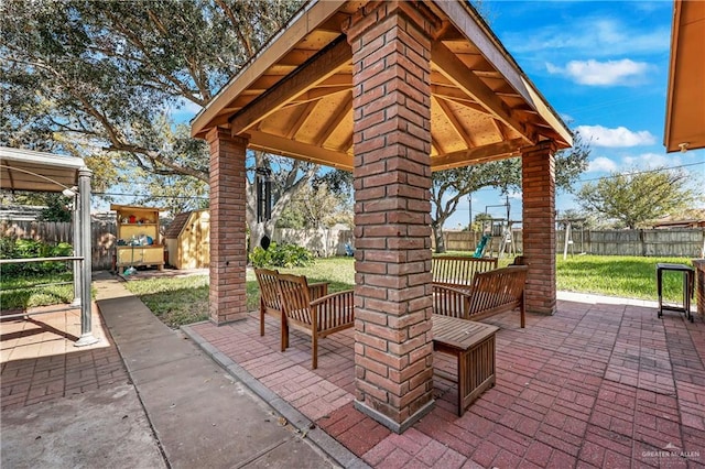 view of patio with a playground, a gazebo, and a storage shed